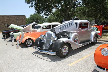 2 vintage cars on display