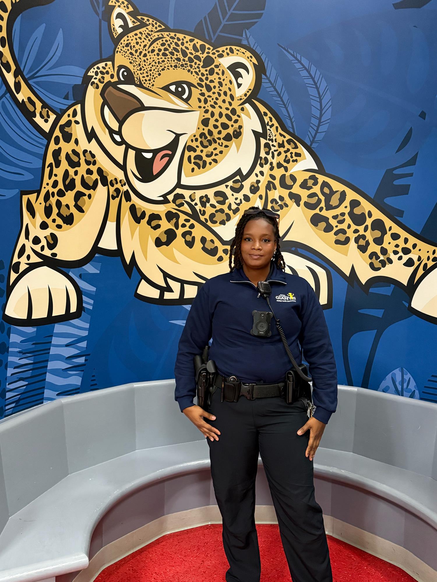 Picture of Officer Hunter in front of Jaguar painting