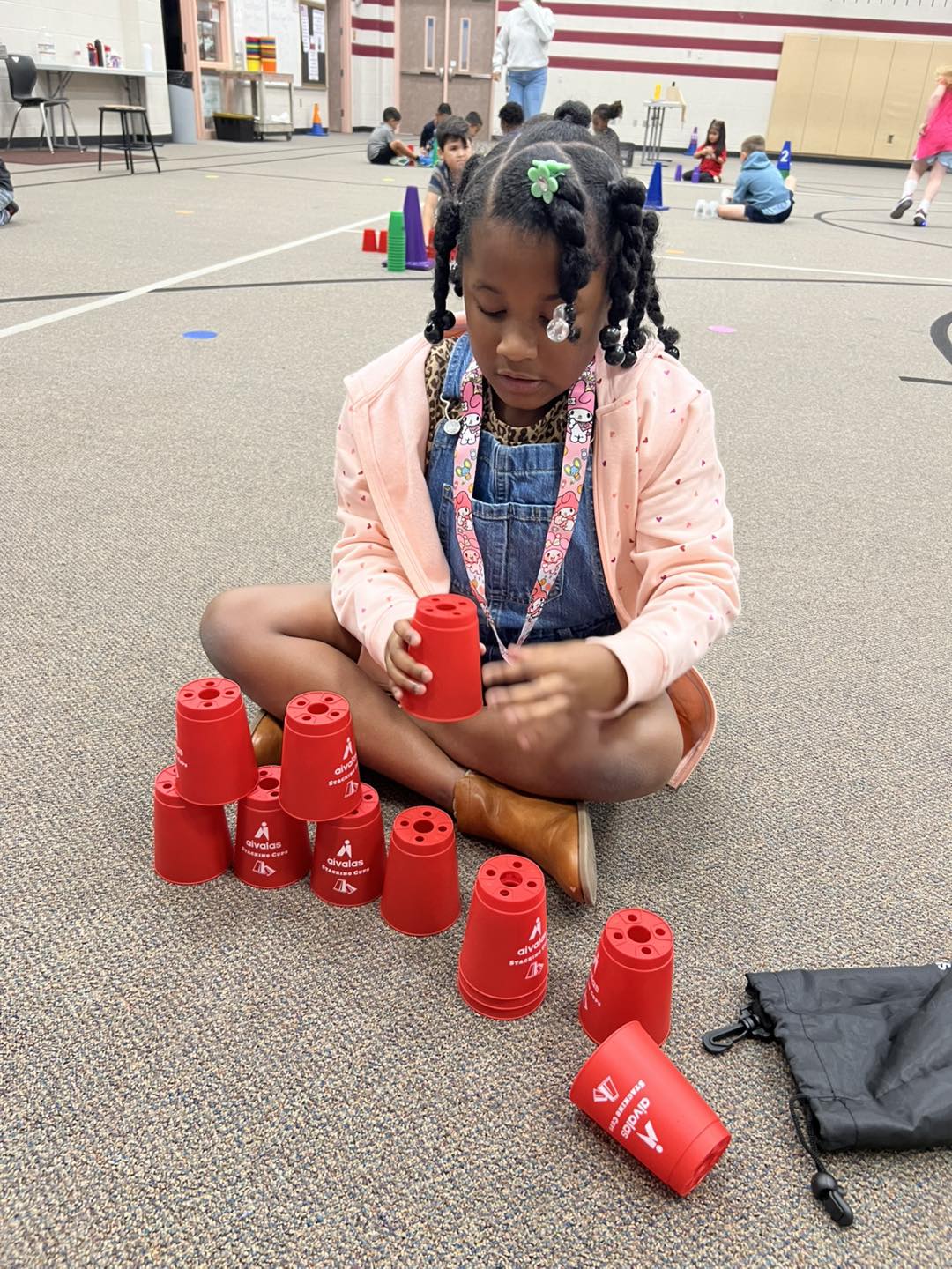 student trying to stack cups for the world record